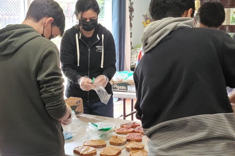 Chani Modi of Imprint Kindness packing PB&J sandwiches made by middle school children.