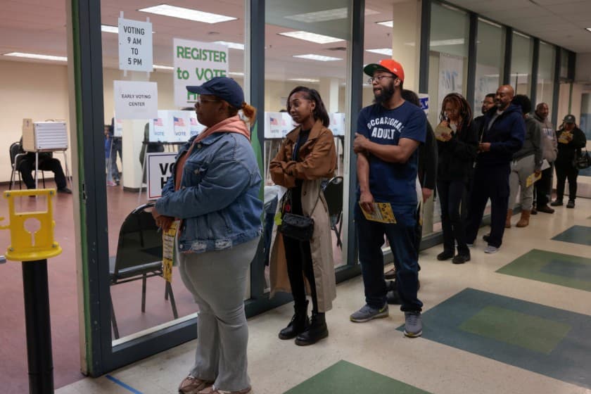 Voters wait in line to cast their votes during early voting in the U.S. presidential election at a polling station in Detroit, Michigan, U.S. November 3, 2024. REUTERS/Rebecca Cook