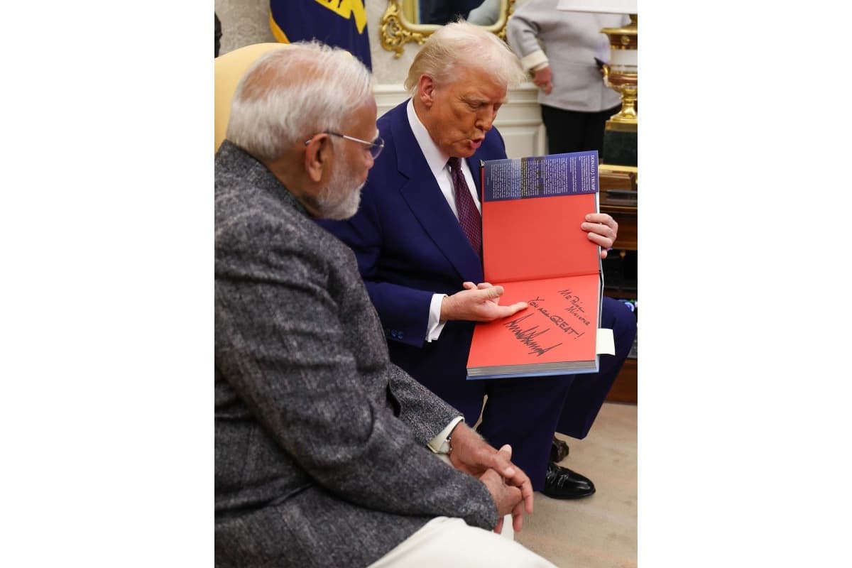 President Trump signing his book for PM Modi.