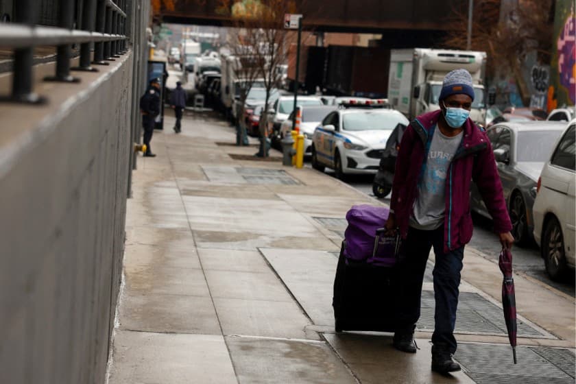  man walks with his belongings before entering a new 2,200-bed migrant men's shelter in the Bronx borough of New York City, U.S., February 27, 2025. REUTERS/Shannon Stapleton/File Photo