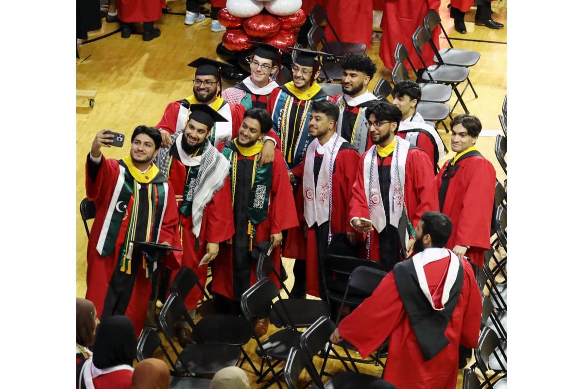 Indian students taking selfie at the commencement. 