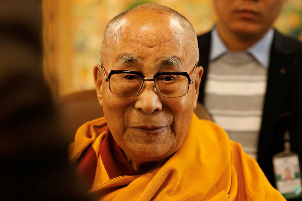 Tibetan spiritual leader, the Dalai Lama, offers blessings to his followers at his Himalayan residence in the northern hill town of Dharamshala, India, December 20, 2024. 