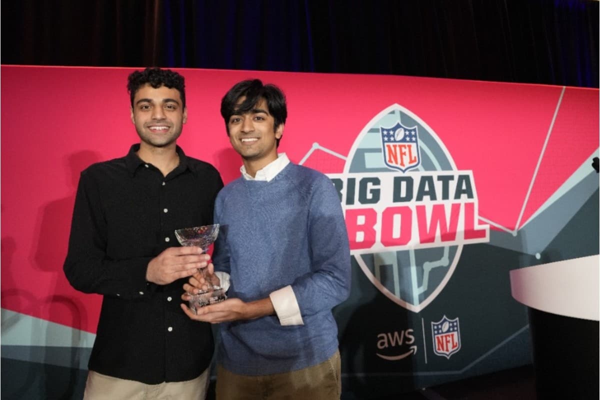 NYU's Smit Bajaj (left) and Vishakh Sandwar (right) proudly pose with their trophy after winning the NFL's 2025 Big Data Bowl.