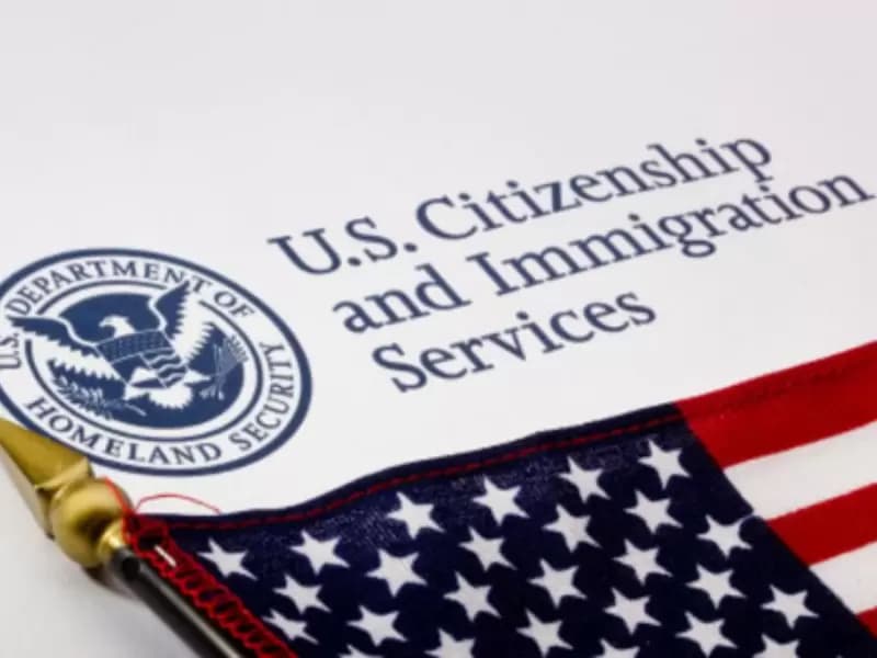 USCIS  logo and U.S. flag