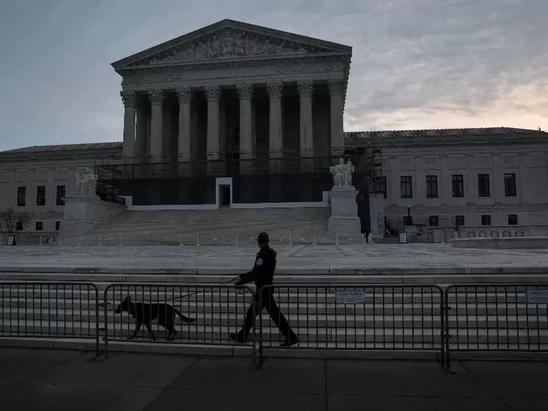 FILE PHOTO: A U.S. Supreme Court Police canine unit patrols in front of the court building at the start of the day in Washington, D.C., U.S., January 9, 2026. 