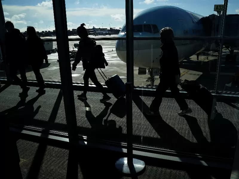 Passengers make their way through the terminal as they travel ahead of the Thanksgiving holiday at Washington Dulles International Airport in Dulles, Virginia, U.S., November 22, 2023. 