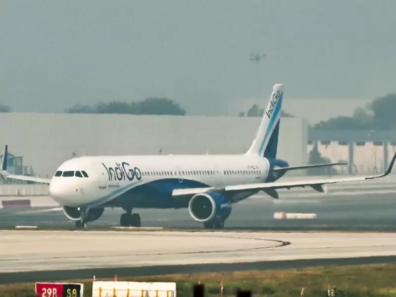 An IndiGo aircraft stands parked on the runway at the Indira Gandhi International Airport as several IndiGo flights continue to be cancelled or delayed in New Delhi on Saturday, December 6, 2025.