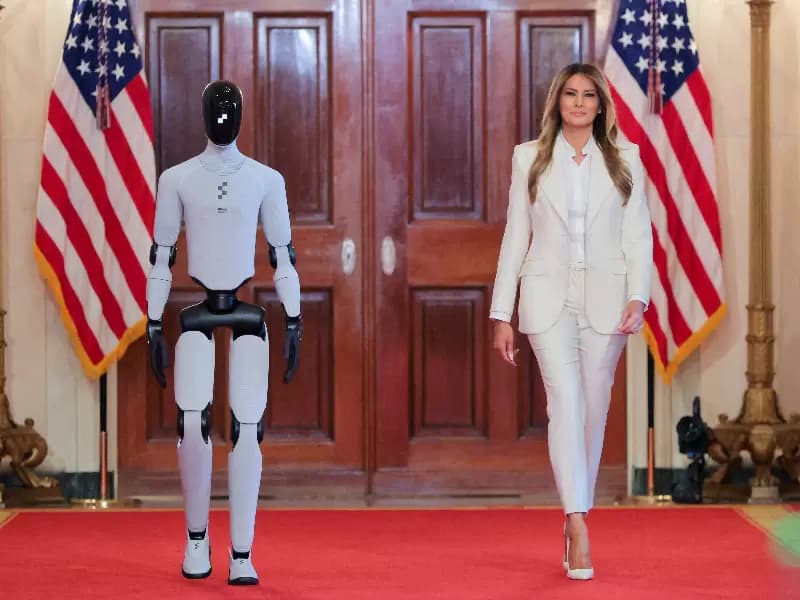 U.S. first lady Melania Trump walks next to a humanoid robot as she hosts a roundtable event on the second day of the inaugural Fostering the Future Together Global Coalition Summit, at the White House in Washington, D.C., U.S., March 25, 2026. 