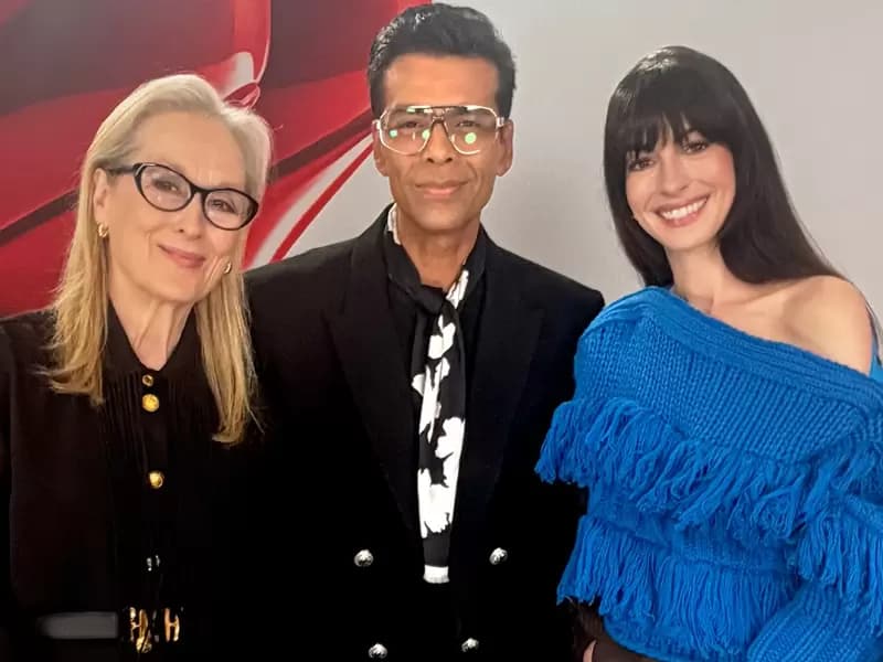 Karan Johar posing with Meryl Streep and Anne Hathaway