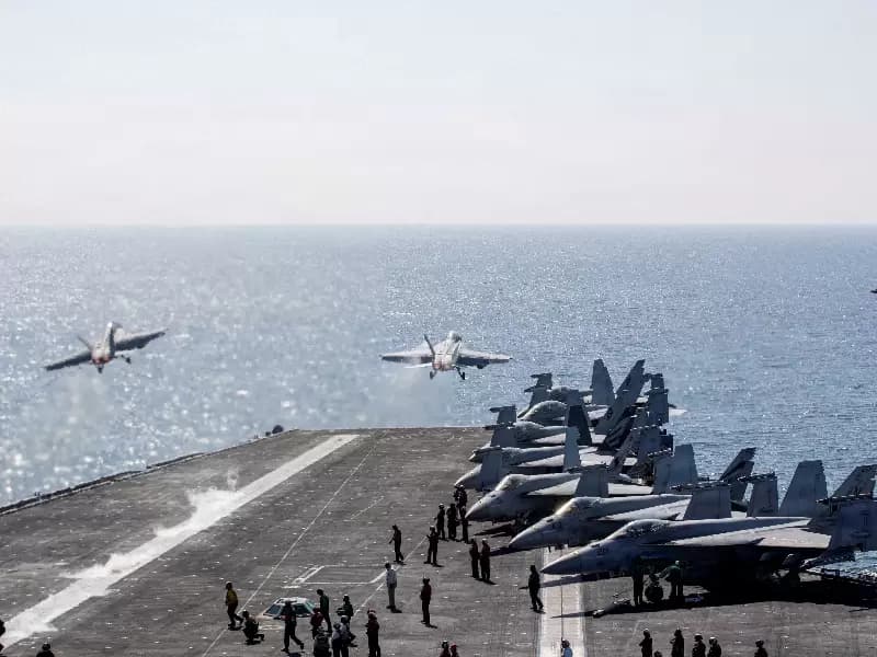 FILE PHOTO: Two F/A-18 Super Hornets launch from the flight deck of the U.S. Navy Nimitz-class aircraft carrier USS Abraham Lincoln in support of the Operation Epic Fury attack on Iran from an undisclosed location March 3, 2026. 