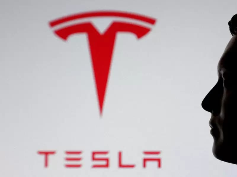 A 3D printed miniature model of Elon Musk's face and Tesla logo are seen in this illustration created onJuly 23, 2025.