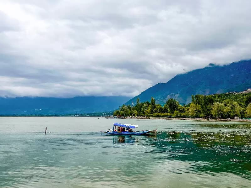 A shikara is anchored along the banks of Dal Lake as clouds hover overhead in Srinagar district of Jammu and Kashmir on Wednesday, April 29, 2026.