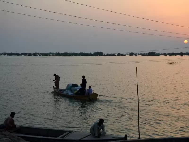  People row boats on flood water in Jamshoro district, Sindh province, Pakistan, Sept. 15, 2022.