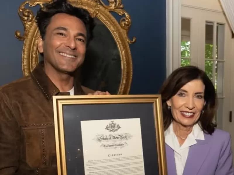 Chef Vikas Khanna and Governor Kathy Hochul posing with the resolution