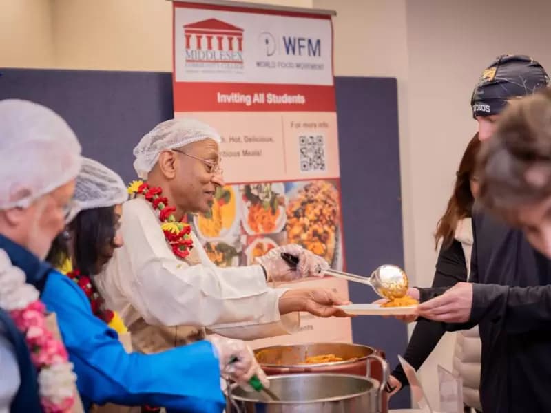 WFM leaders serving food to Middlesex Community College students