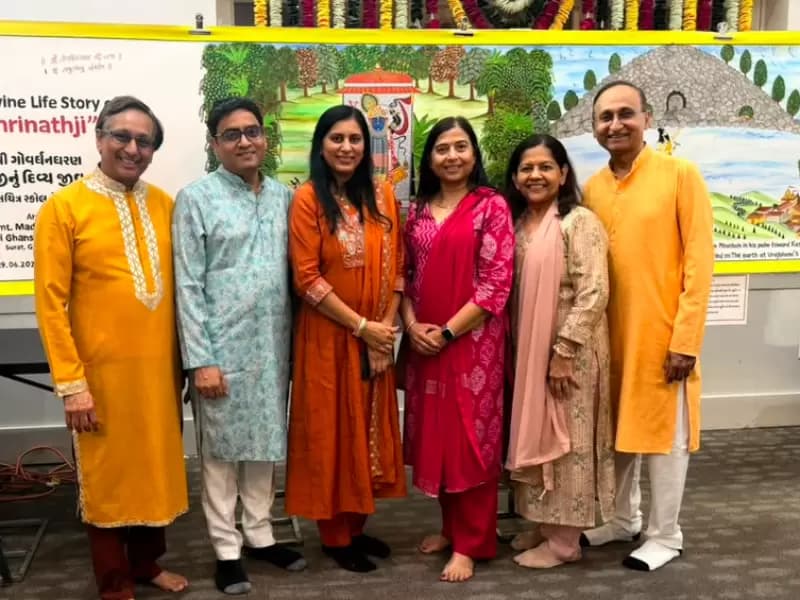 Attendees of the event posing with the painting in the background