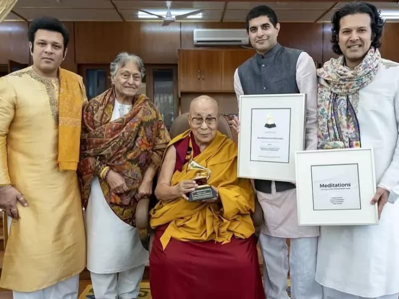 Amjad Ali Khan and sons Amaan Ali Bangash and Ayaan Ali Bangash present the award to the 14th Dalai Lama
