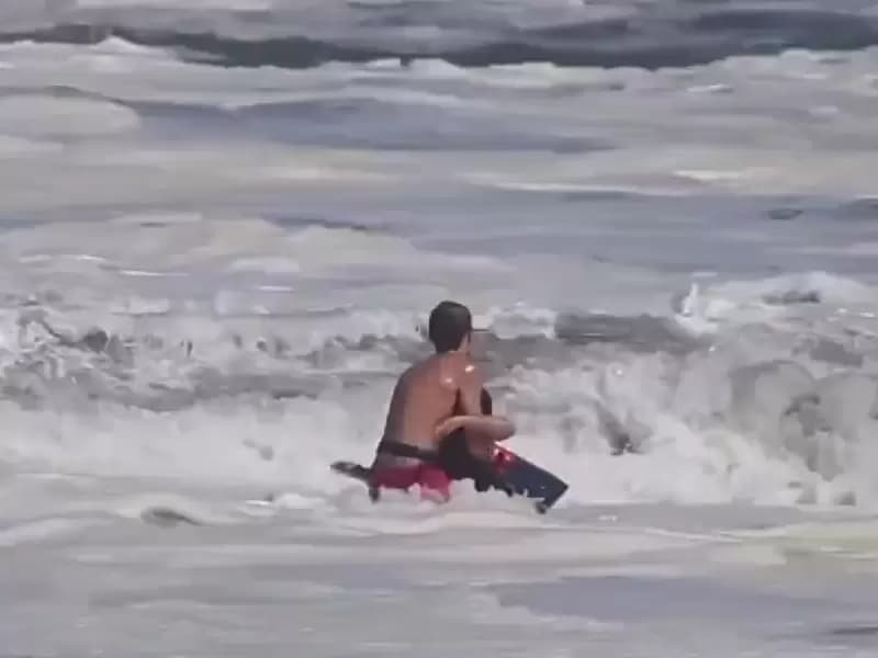 The lifeguard saving the 10-year old boy