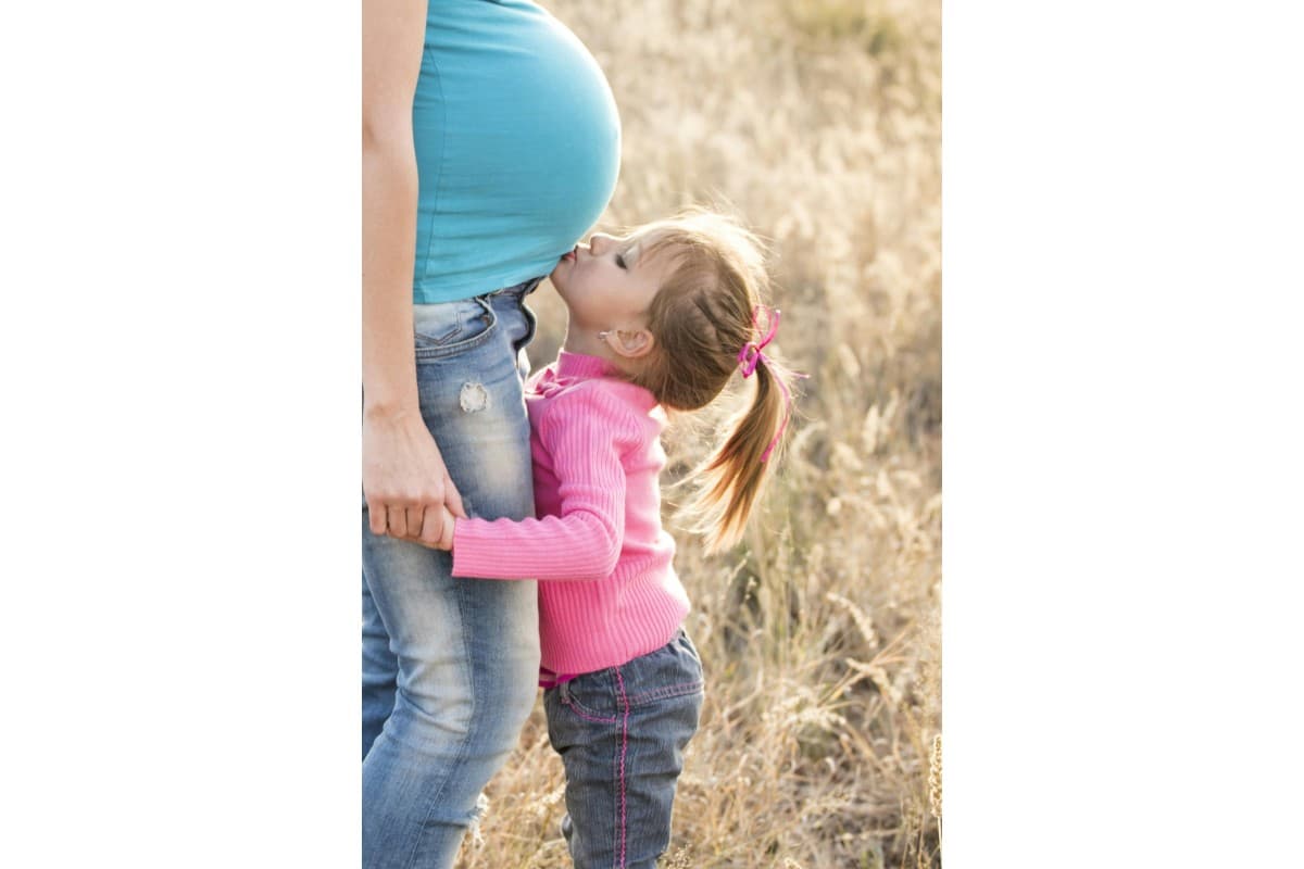 A pregnant woman with her daughter.