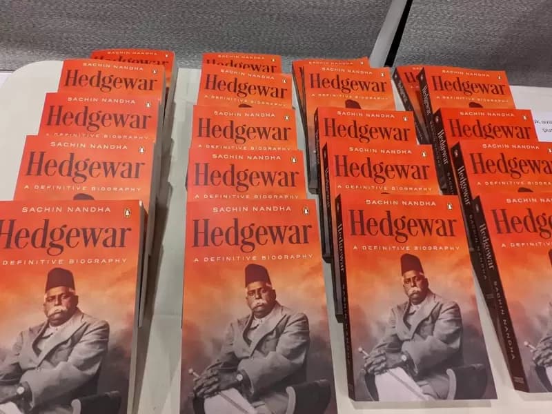 Bright orange copies of Hedgewar: A Definitive Biography on display at the Houston event marking both the book’s launch and the centenary of the Rashtriya Swayamsevak Sangh.
