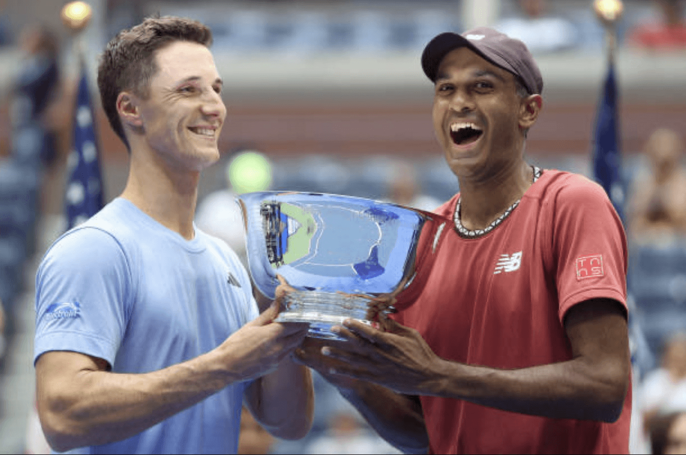 Photo caption: Rajeev Ram (right) and Joe Salisbury hold their winning trophy at the 2023 US Open.