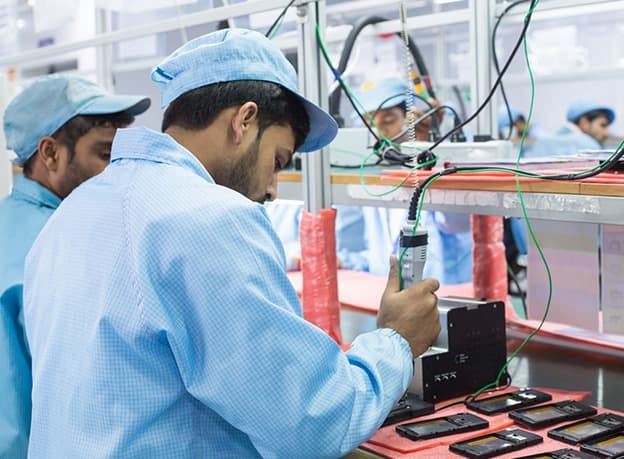 Assembling mobile phones in a plant of India-based consumer electronics contract manufacturer Dixon