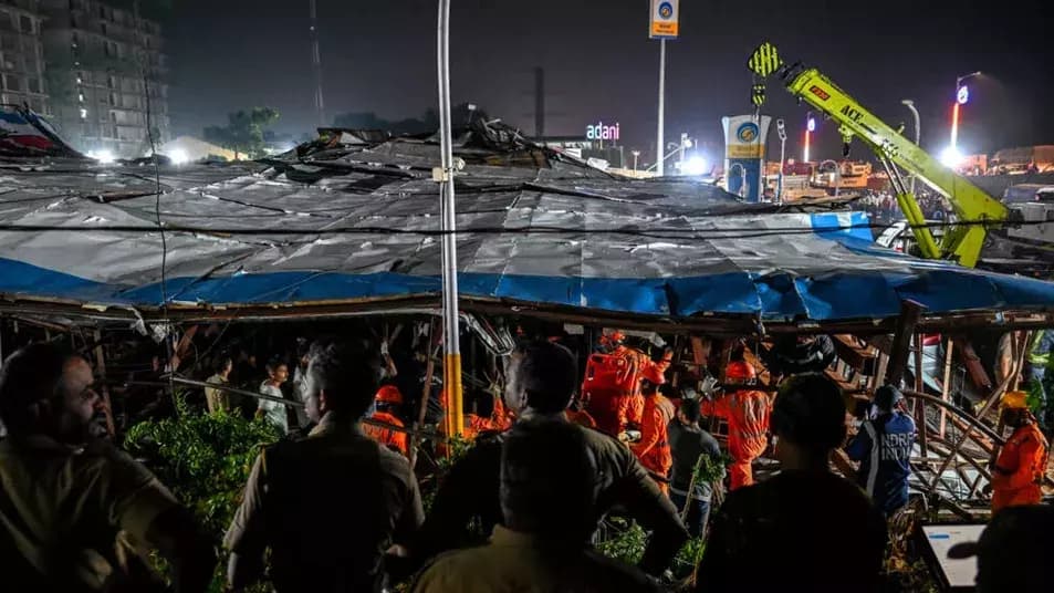 National Disaster Response Force (NDRF) personnel look for survivors during a rescue operation at the site where an advertisement hoarding collapsed on a fuel station after a dust storm in Mumbai on May.13.
