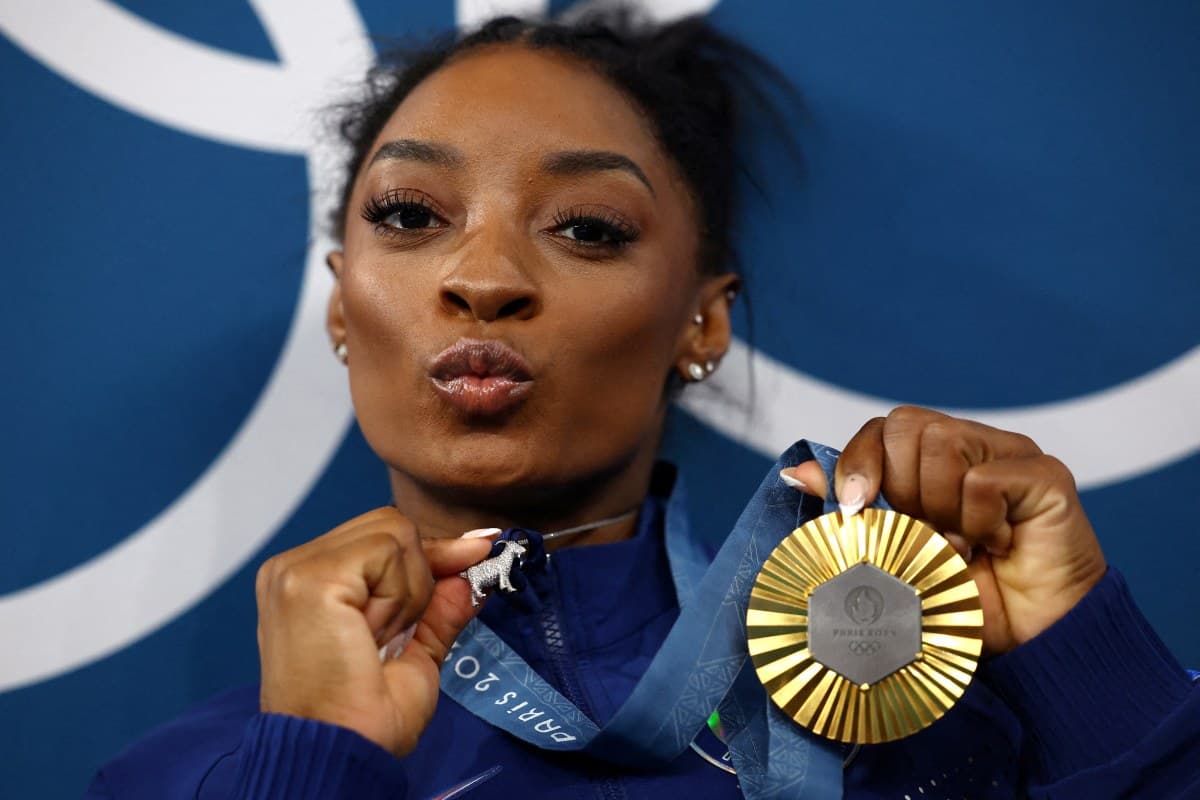 Women's All-Around Victory Ceremony - Bercy Arena, Paris, France - August 01, 2024. Gold medallist Simone Biles of United States celebrates with her medal.