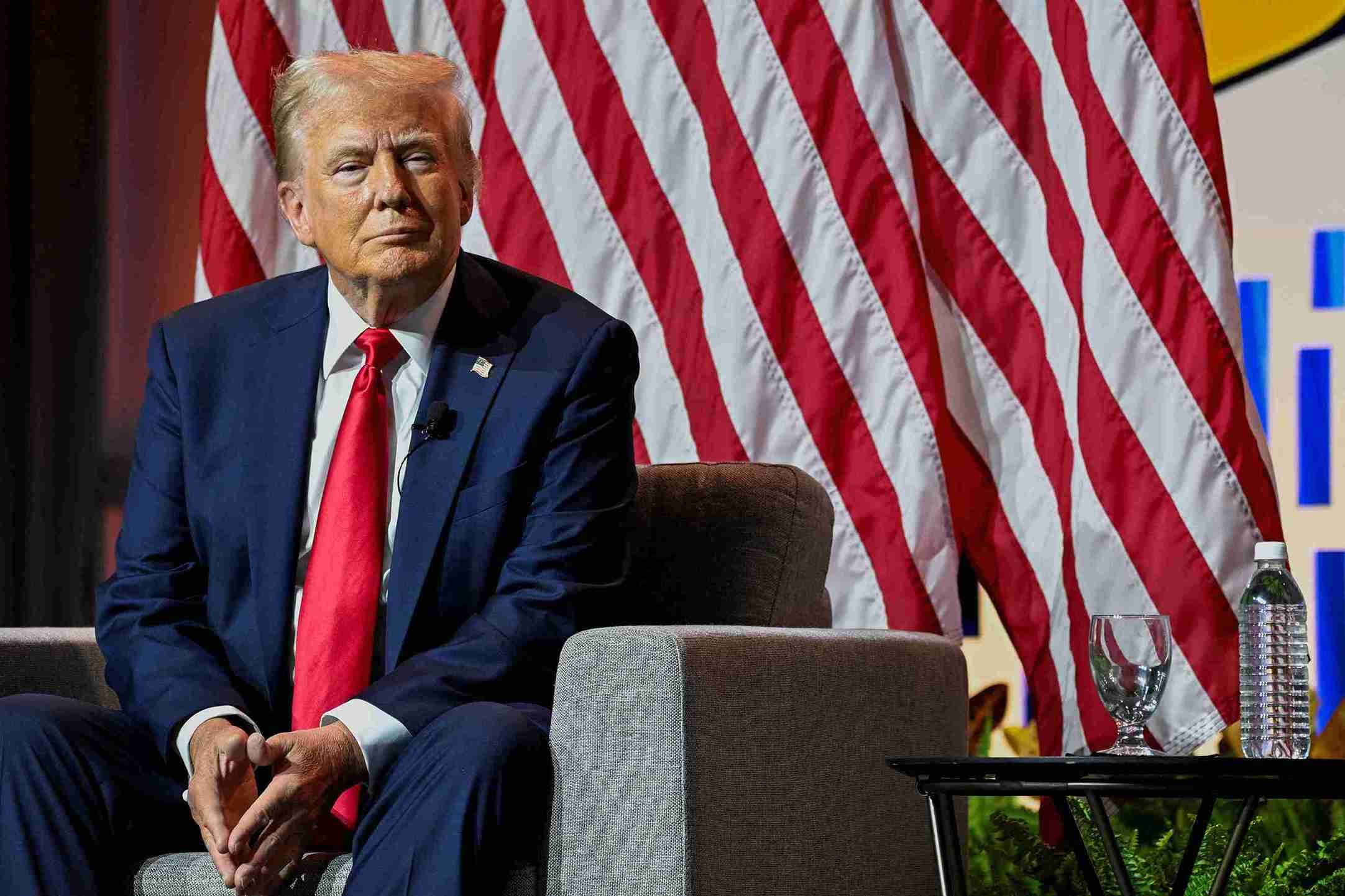 Donald Trump smiles while speaking on a panel of the National Association of Black Journalists.