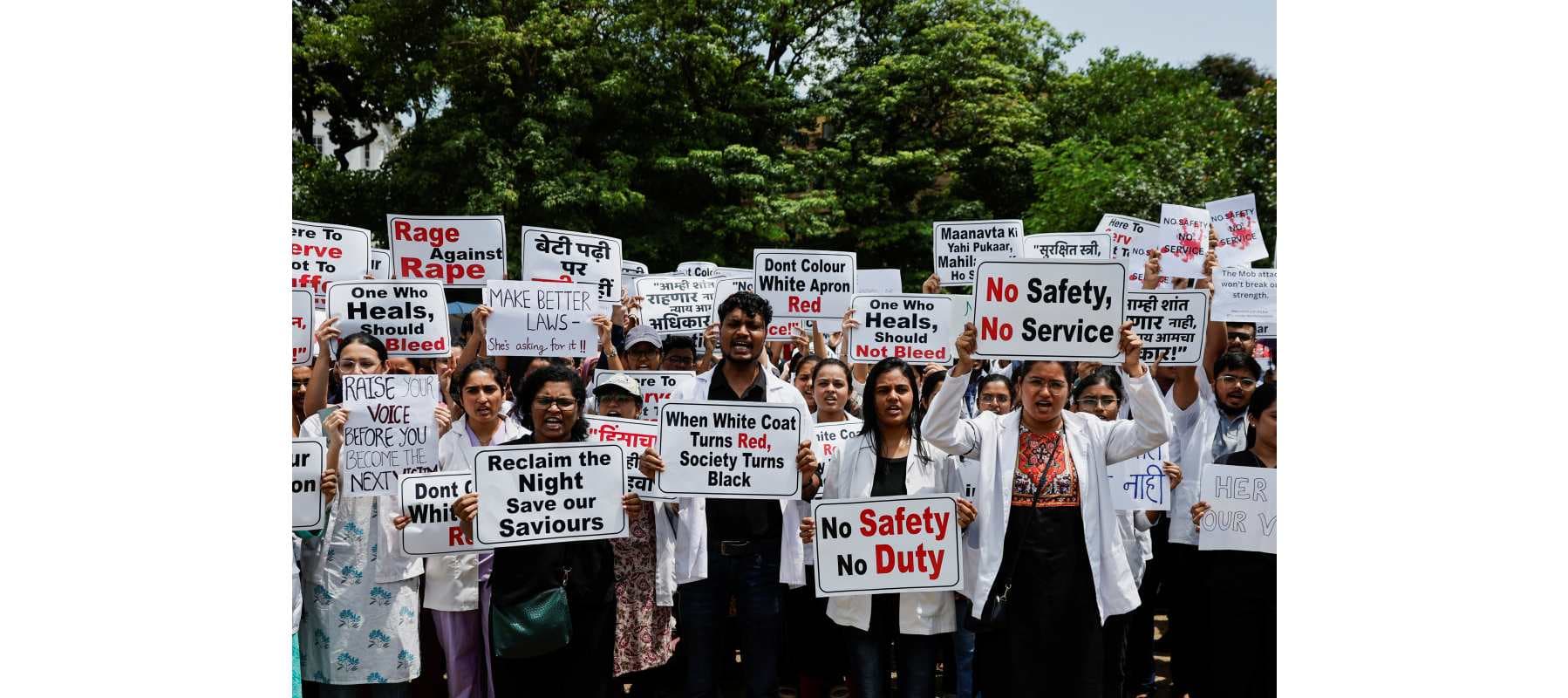 Resident doctors hold posters and shout slogans during a protest, condemning the rape and murder of a trainee medic at a government-run hospital in Kolkata, at a ground in Mumbai, India, Aug.16, 2024.