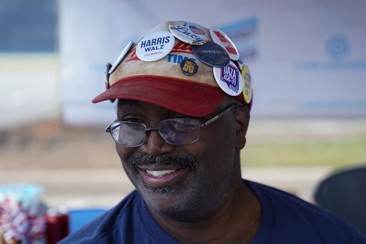 Nathaniel Gray, a volunteer at the Cobb Democrats booth at the Pigs and Peaches country festival in Kennesaw, Georgia, Aug.17, 2024.