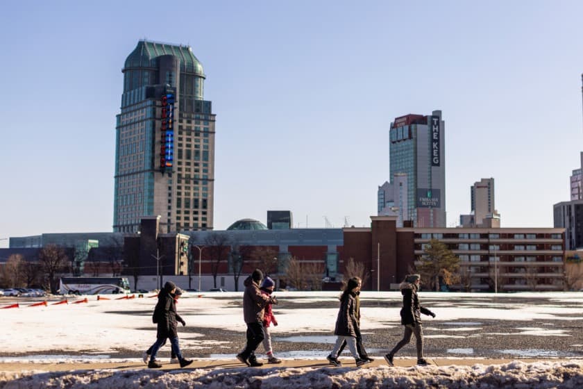 A group of people walk along a road, in Niagara Falls, Ontario, Canada March 7, 2023. REUTERS/Carlos Osorio