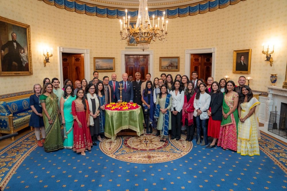 President Joe Biden poses for a photo with White House staff at a diya lighting ceremony in the Blue Room of the White House, Monday, October 28, 2024, before a reception to celebrate Diwali.