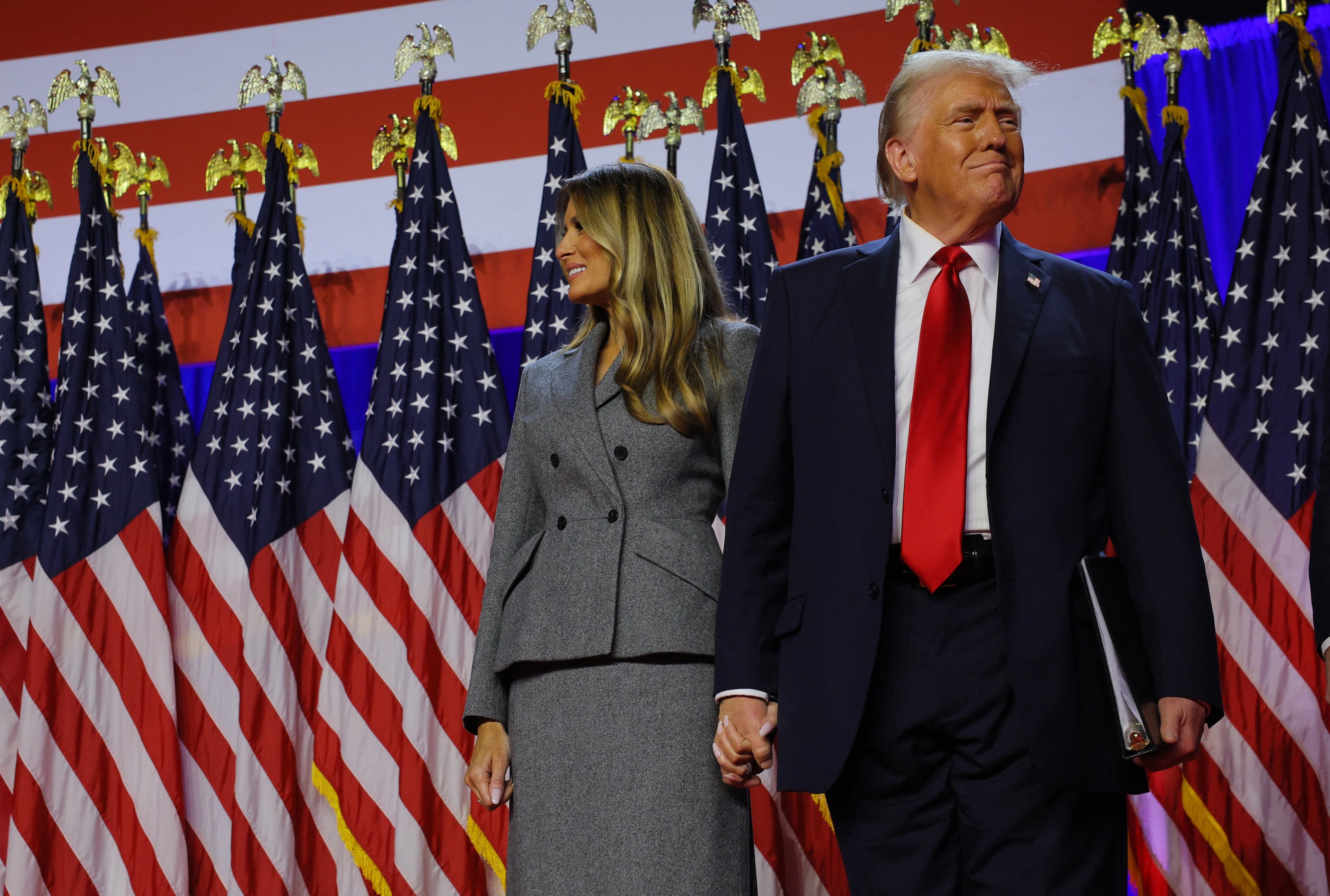 Donald Trump takes the stage with his wife Melania to address supporters at his rally, at the Palm Beach County Convention Center in Florida, U.S., November 6, 2024.