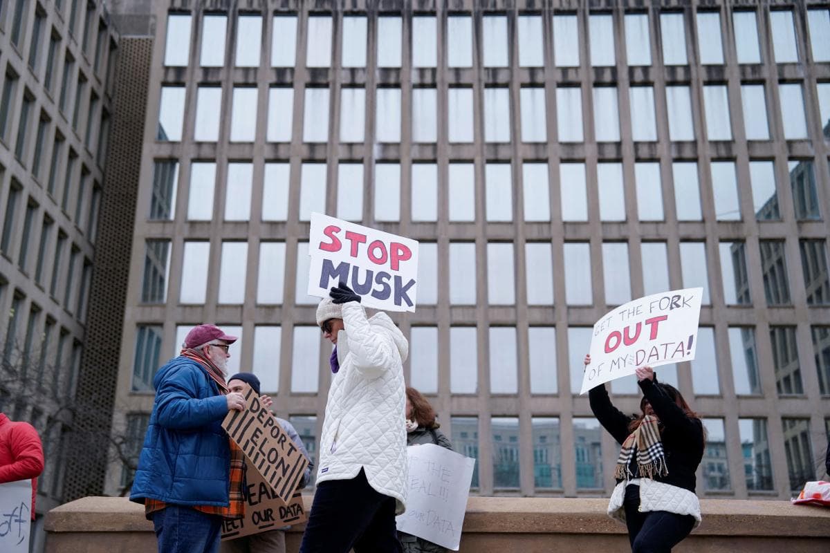 People gather to protest outside the Office of Personnel Management (OPM) headquarters after the Elon Musk-led Department of Government Efficiency (DOGE) was charged with oversight of OPM, in Washington, U.S. February 2, 2025.