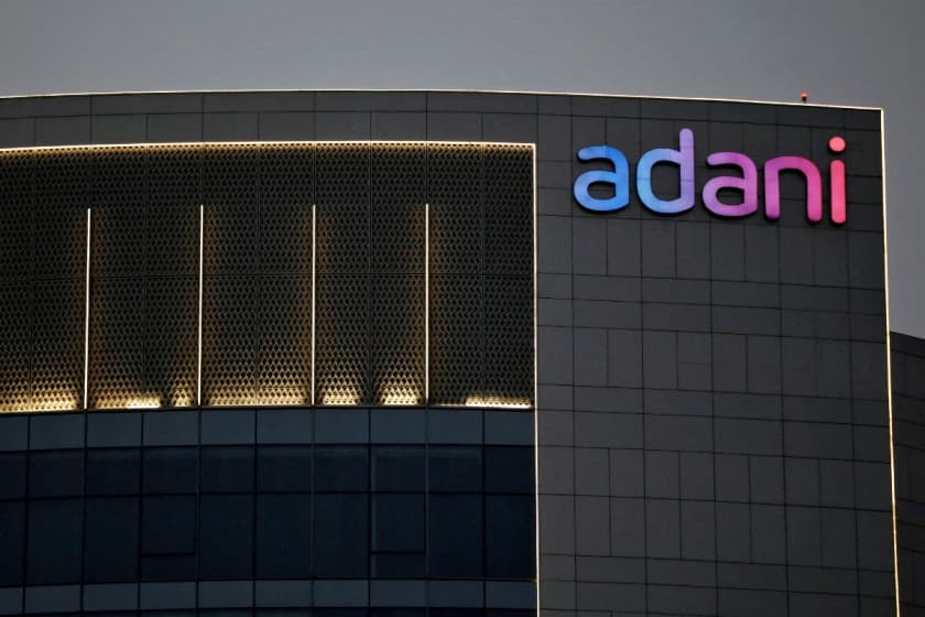 The logo of the Adani Group is seen on the facade of one of its buildings on the outskirts of Ahmedabad, India, April 13, 2021. REUTERS/Amit Dave/File Photo