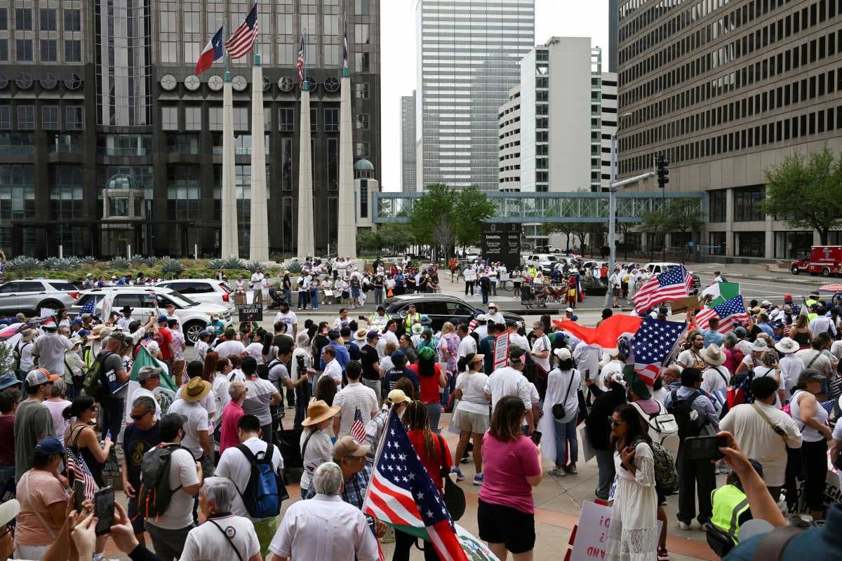 Demonstrators gather outside of the National Shrine Cathedral of Our Lady of Guadalupe before walking through the streets of downtown during the