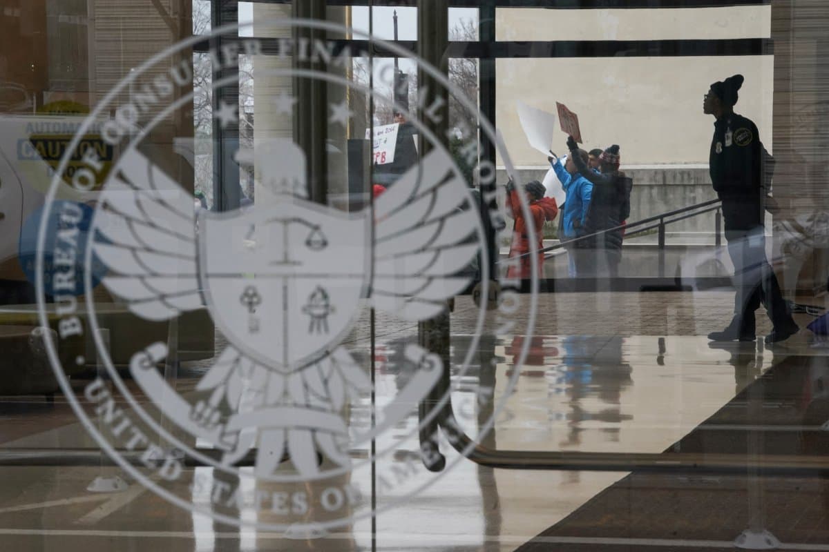 A special police member monitors a protest, while inside the Consumer Financial Protection Bureau (CFPB) building, the day after members of Elon Musk's Department of Government Efficiency (DOGE) moved into the CFPB, in Washington, U.S. February 8, 2025.