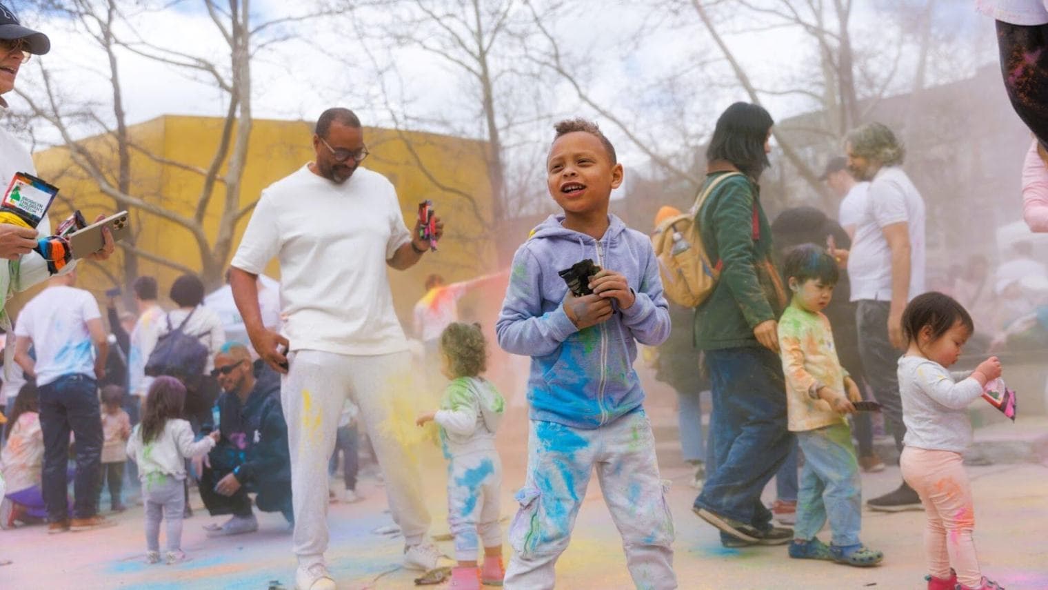 Families in Brower Park throwing colors during Celebrate Holi at BCM.