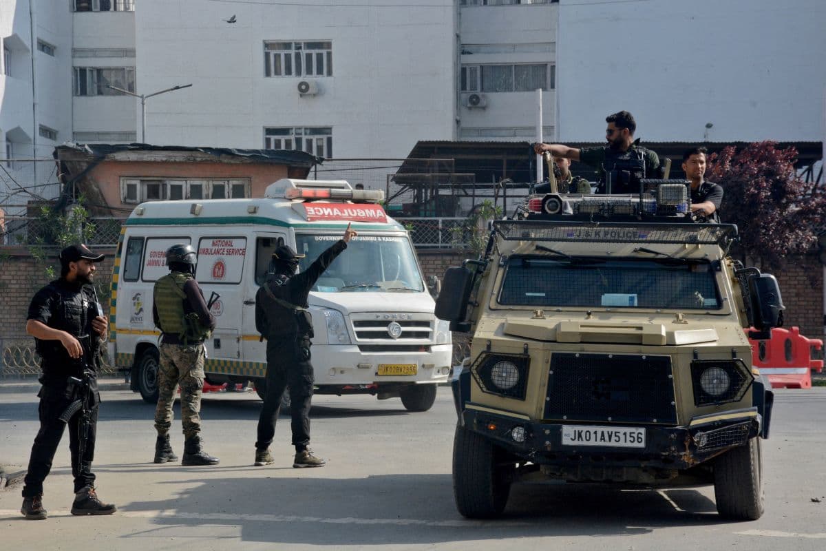 Indian security forces personnel escort an ambulance carrying the bodies of tourists who were killed in a suspected militant attack near Pahalgam, outside the police control room in Srinagar April 23, 2025.