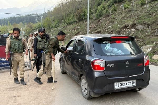 Indian police officers stop a vehicle at a check point following a suspected militant attack, near Pahalgam in south Kashmir's Anantnag district, April 22, 2025.