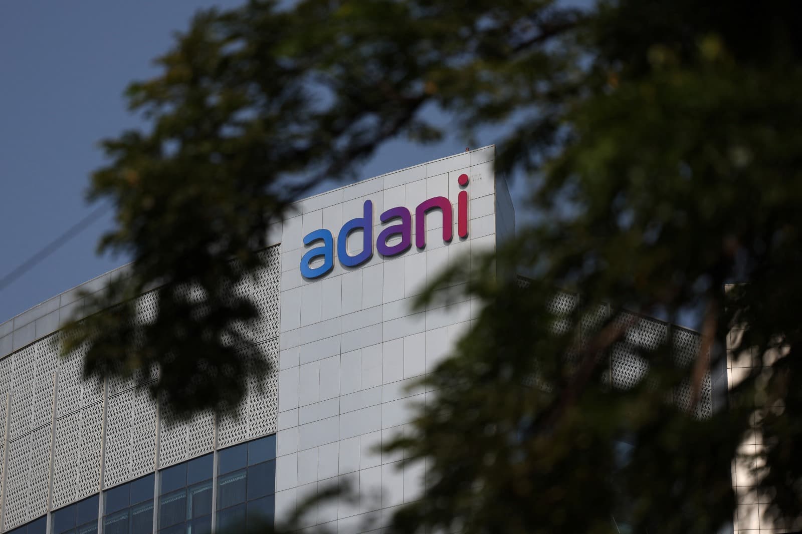 The logo of the Adani Group is seen on the facade of its Corporate House on the outskirts of Ahmedabad, India, November 21, 2024.