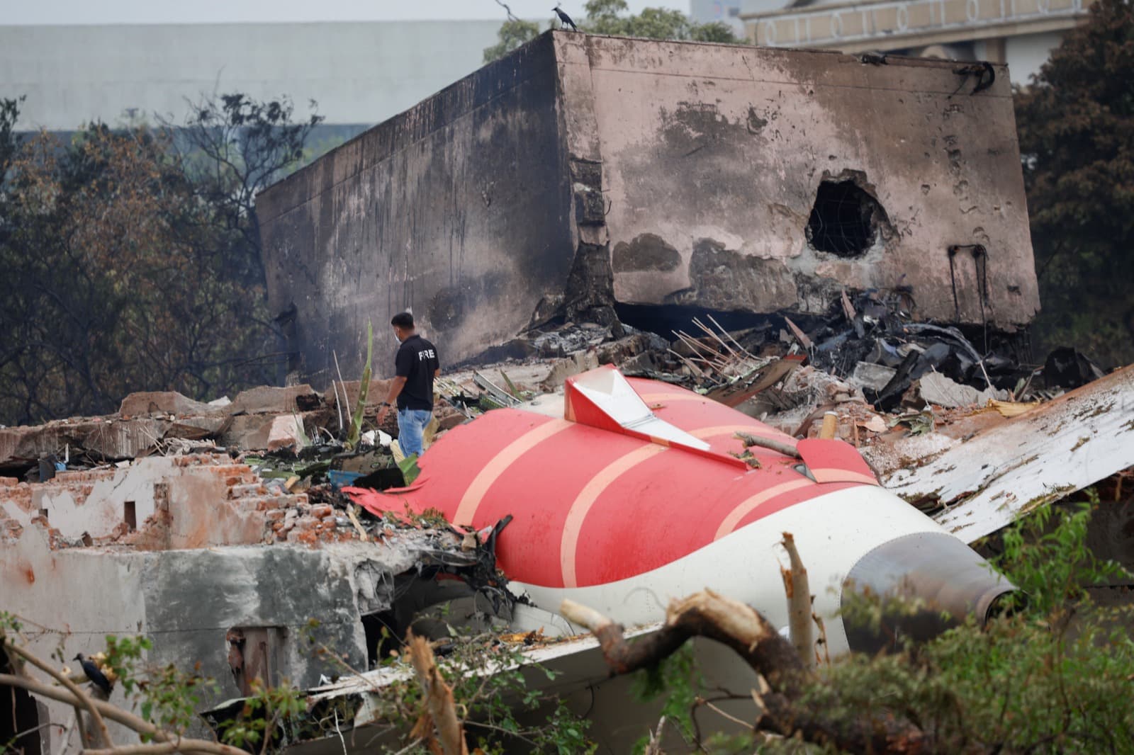 A fire offical stands next to the crashed Air India Boeing 787-8 Dreamliner aircraft, in Ahmedabad, India, June 13, 2025.