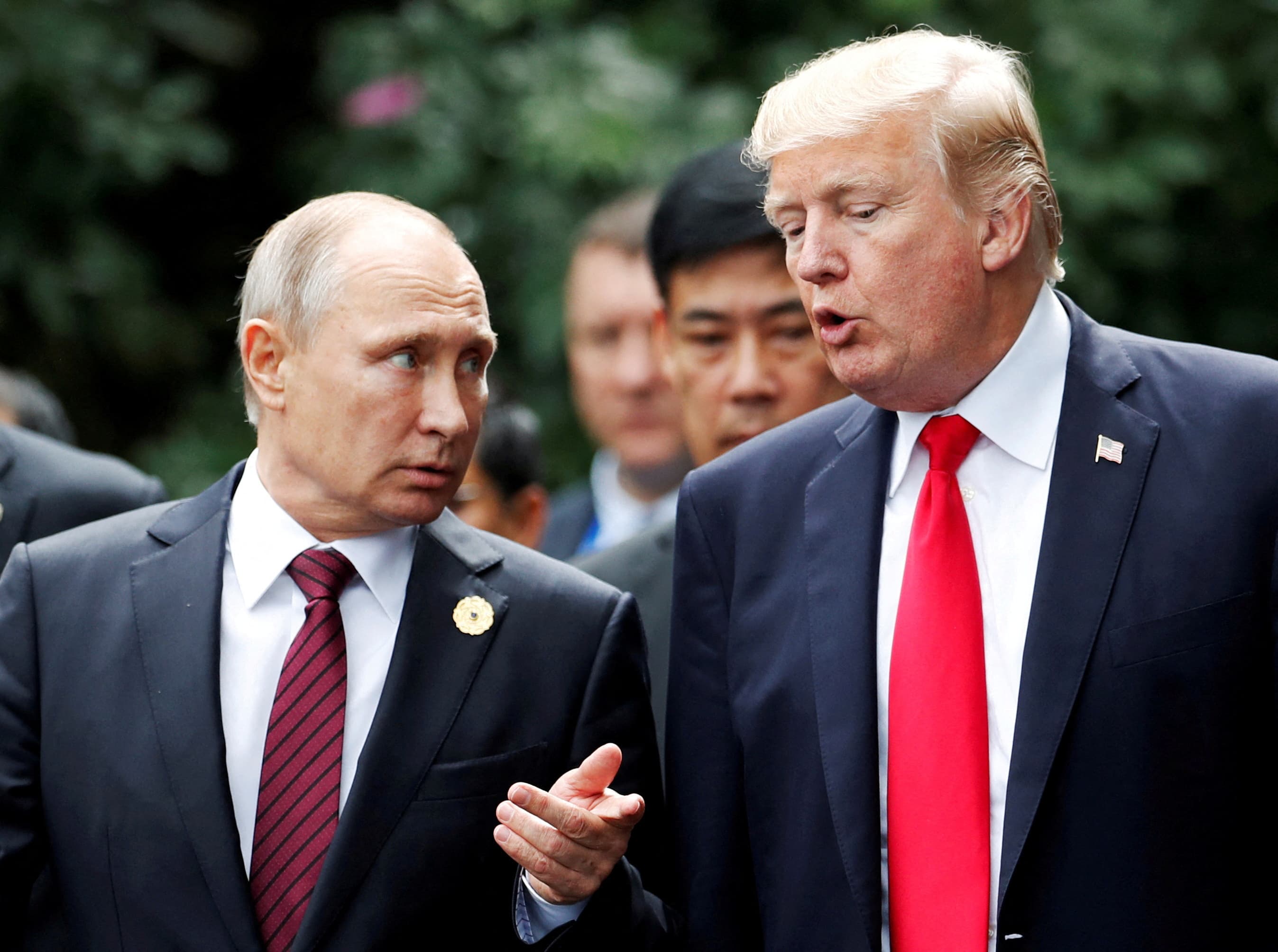 U.S. President Donald Trump and Russia's President Vladimir Putin talk during the family photo session at the APEC Summit in Danang, Vietnam November 11, 2017.