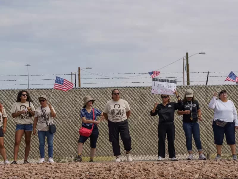 Protesters opposing mass deportations by ICE hold signs during a protest held at the Cassidy Gate at Fort Bliss, the U.S. Army base where a large new ICE detention facility is being built, in El Paso, Texas, U.S., August 17, 2025.