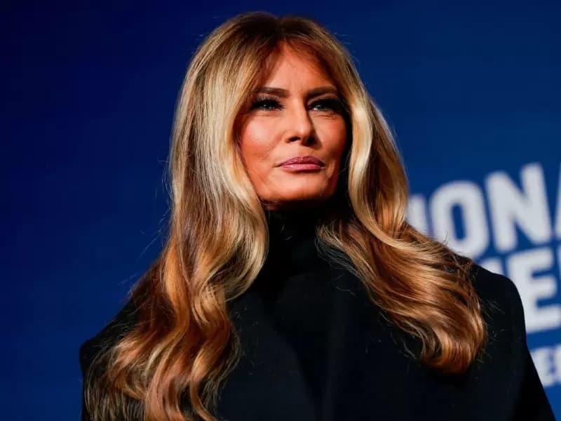 U.S. first lady Melania Trump stands next to her 2025 inaugural gown in the Flag Hall of the Smithsonian's National Museum of American History in Washington, D.C., U.S., February 20, 2026.