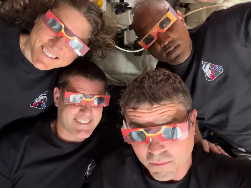 The Artemis II crew of NASA astronauts Christina Koch, Reid Wiseman, Victor Glover and Canadian Space Agency (CSA) astronaut Jeremy Hansen pose with their eclipse glasses used to protect their eyes for the Orion spacecraft's flyby of the Moon April 6, 2026. Picture taken with a mobile phone.