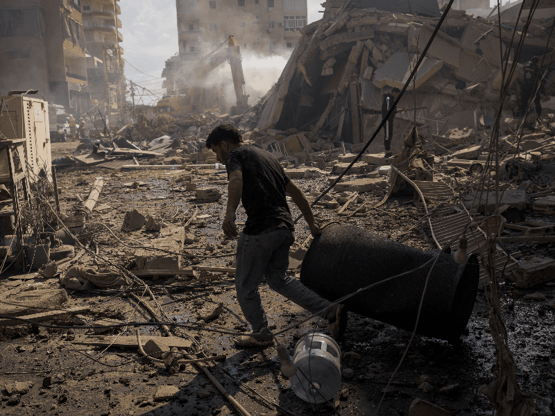 A man pulls a drum at the site of an Israeli strike in Tyre, Lebanon, April 8, 2026.