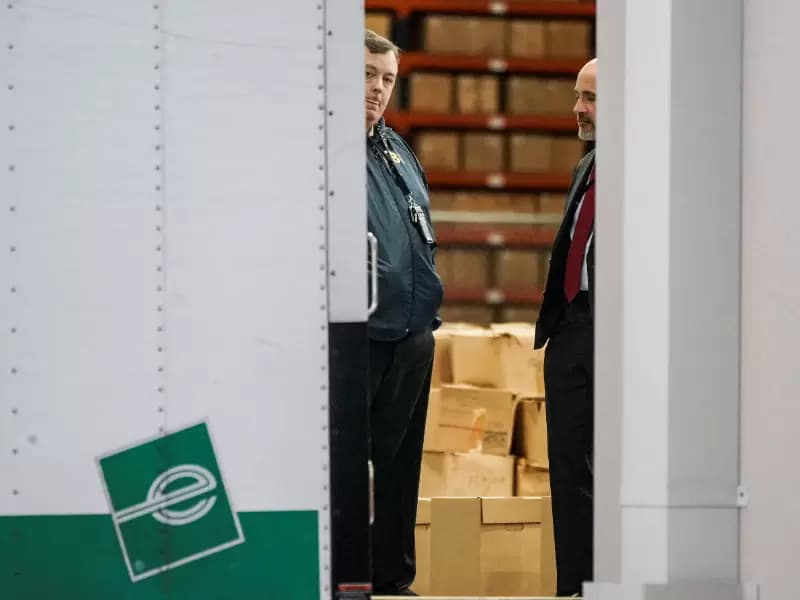 Members of the Federal Bureau of Investigation (FBI) stand inside a vehicle loaded with boxes outside the Fulton County Election Hub and Operation Center after the FBI executed a search warrant there in relation to the 2020 election, according to a law enforcement official familiar with the matter, in Union City, Georgia, U.S. January 28, 2026.