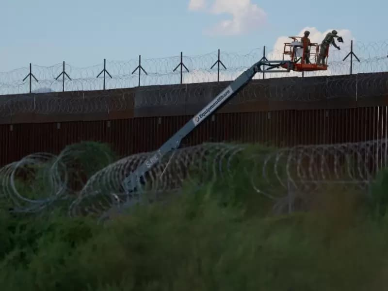 U.S. Army combat engineers place razor wire on the U.S.-Mexico border wall to reinforce security in El Paso Texas, as seen from Ciudad Juarez, Mexico July 24, 2025.